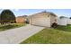 Home exterior with a two car garage and long driveway at 6610 Crescent Loop, Winter Haven, FL 33884