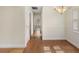 Inviting hallway with hardwood floors leading to bright and airy rooms at 6610 Crescent Loop, Winter Haven, FL 33884