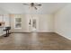 Open-concept living room with tile flooring, a ceiling fan, and access to the outdoor patio at 6610 Crescent Loop, Winter Haven, FL 33884