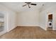 Spacious living room with tile flooring, a ceiling fan, and access to the laundry room at 6610 Crescent Loop, Winter Haven, FL 33884