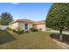 Single-story home with neutral exterior, manicured lawn, and well-placed landscaping at 6610 Crescent Loop, Winter Haven, FL 33884