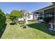 Spacious backyard featuring a well manicured lawn, privacy hedges, and plantings at 6962 Starmount Dr, Lakeland, FL 33810