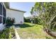 Landscaped backyard featuring a well manicured lawn, privacy hedges, and plantings at 6962 Starmount Dr, Lakeland, FL 33810