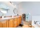 Bathroom featuring a double vanity with a tile countertop and decorative lighting at 6962 Starmount Dr, Lakeland, FL 33810