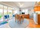 Cozy dining area featuring a ceiling fan, a table, and access to the screened in lanai at 6962 Starmount Dr, Lakeland, FL 33810