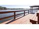 Waterfront dock area featuring wooden deck, seating, and a covered gazebo, ideal for lakeside relaxation at 6962 Starmount Dr, Lakeland, FL 33810