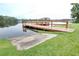 Wooden community dock and boat launch on a peaceful lake with lush green surroundings at 6962 Starmount Dr, Lakeland, FL 33810