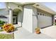 Close up of front entrance with portico, attached two car garage, and manicured lawn at 6962 Starmount Dr, Lakeland, FL 33810