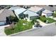 Aerial view of home featuring a well maintained front yard with a green lawn and trees at 6962 Starmount Dr, Lakeland, FL 33810