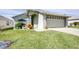 Inviting single-story home featuring well-manicured lawn, two-car garage, and meticulously maintained landscaping at 6962 Starmount Dr, Lakeland, FL 33810