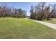 Expansive green space with walking path lined with mature trees, perfect for outdoor activities at 6962 Starmount Dr, Lakeland, FL 33810