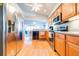 Bright kitchen featuring stainless steel appliances, wood cabinets, and wood floors at 6962 Starmount Dr, Lakeland, FL 33810