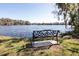 Scenic lake view from the wrought-iron bench, providing a serene spot to relax at 6962 Starmount Dr, Lakeland, FL 33810