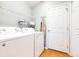 Functional laundry room with washer, dryer, and storage shelves at 6962 Starmount Dr, Lakeland, FL 33810