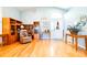 Open-concept living room with hardwood floors, neutral walls, and a decorative front door at 6962 Starmount Dr, Lakeland, FL 33810