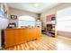 Office featuring wood laminated floors, desk, shelving, and a large window at 6962 Starmount Dr, Lakeland, FL 33810
