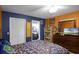 Spacious bedroom with a queen bed, ensuite bathroom, and built-in shelving at 7026 Parliament Pl, Lakeland, FL 33809