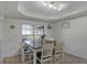 Bright dining room with wood table and white chairs at 7026 Parliament Pl, Lakeland, FL 33809