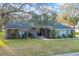 Charming single-story home featuring mature landscaping and a welcoming brick-accented entryway at 7026 Parliament Pl, Lakeland, FL 33809