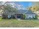Charming single-story home featuring mature landscaping and a welcoming brick-accented entryway at 7026 Parliament Pl, Lakeland, FL 33809