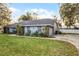 One-story home with a large yard and mature trees at 7026 Parliament Pl, Lakeland, FL 33809