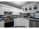 A modern kitchen with stainless steel appliances, white cabinets, and a corner sink at 7026 Parliament Pl, Lakeland, FL 33809