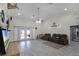 Large living room with high ceilings, tile floors, and access to the pool at 7026 Parliament Pl, Lakeland, FL 33809