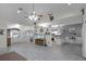 Open living room and kitchen with tile floors and a large TV at 7026 Parliament Pl, Lakeland, FL 33809