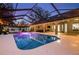 Stunning screened pool at twilight with surrounding patio at 7026 Parliament Pl, Lakeland, FL 33809