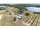 Aerial view of home and property with lake access, large lawn and well-maintained landscaping at 705 Lake Ada Blvd, Dundee, FL 33838