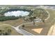 Wide aerial shot of the home, showing the lake, large lot and surrounding area at 705 Lake Ada Blvd, Dundee, FL 33838
