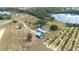 Aerial view of home and property with lake access, large lawn and well-maintained landscaping at 705 Lake Ada Blvd, Dundee, FL 33838
