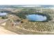 Expansive aerial view of the property, showcasing a home, lake and surrounding grove at 705 Lake Ada Blvd, Dundee, FL 33838