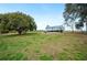 Expansive backyard with lush grass and mature trees, perfect for outdoor activities and relaxation at 705 Lake Ada Blvd, Dundee, FL 33838