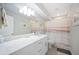 Bright bathroom with a vanity, and a shower tub featuring a decorative curtain at 705 Lake Ada Blvd, Dundee, FL 33838