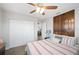 Comfortable bedroom with a plush bed, wood closet, and large windows allowing for lots of natural light at 705 Lake Ada Blvd, Dundee, FL 33838