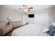 Bedroom featuring a cozy armchair, ceiling fan, and ample closet space at 705 Lake Ada Blvd, Dundee, FL 33838