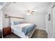 Bright bedroom featuring a queen bed, ceiling fan, and wood-look flooring at 705 Lake Ada Blvd, Dundee, FL 33838