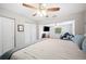Open bedroom with ceiling fan, closet, and sitting area with tv at 705 Lake Ada Blvd, Dundee, FL 33838