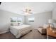 Bright bedroom with a comfortable bed, soft carpeting, and serene views from the window at 705 Lake Ada Blvd, Dundee, FL 33838