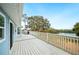 Enjoy lake views from the spacious deck, with a gas grill for outdoor cooking and white railings at 705 Lake Ada Blvd, Dundee, FL 33838