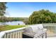 Enjoy grilling on the deck with a beautiful backdrop of a tranquil lake and green trees at 705 Lake Ada Blvd, Dundee, FL 33838