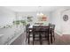 Dining room boasts large table, ample seating, and natural light at 705 Lake Ada Blvd, Dundee, FL 33838