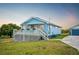 Charming single-story home with blue siding, a front porch, and a well-manicured lawn at 705 Lake Ada Blvd, Dundee, FL 33838