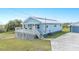 Charming home with a front deck, white railings and a well-maintained lawn at 705 Lake Ada Blvd, Dundee, FL 33838
