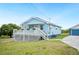 Charming single-story home with light blue siding, a cozy front porch, and well-maintained landscaping at 705 Lake Ada Blvd, Dundee, FL 33838