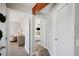 Hallway with decorative wood beam leads to bedrooms, highlighting the home's unique design and functionality at 705 Lake Ada Blvd, Dundee, FL 33838
