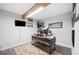 Dedicated home office space with rustic desk, enhanced by a wooden ceiling beam and neutral walls at 705 Lake Ada Blvd, Dundee, FL 33838