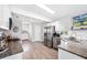 Bright kitchen with stainless steel appliances, granite countertops, and stylish wood flooring at 705 Lake Ada Blvd, Dundee, FL 33838