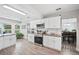 Well-lit kitchen with granite countertops, stainless appliances, and wood-look flooring at 705 Lake Ada Blvd, Dundee, FL 33838